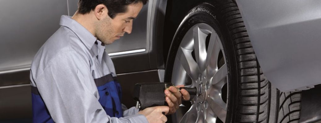 A mechanic checking vehicle tire