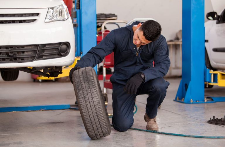 A mechanic checking a tire