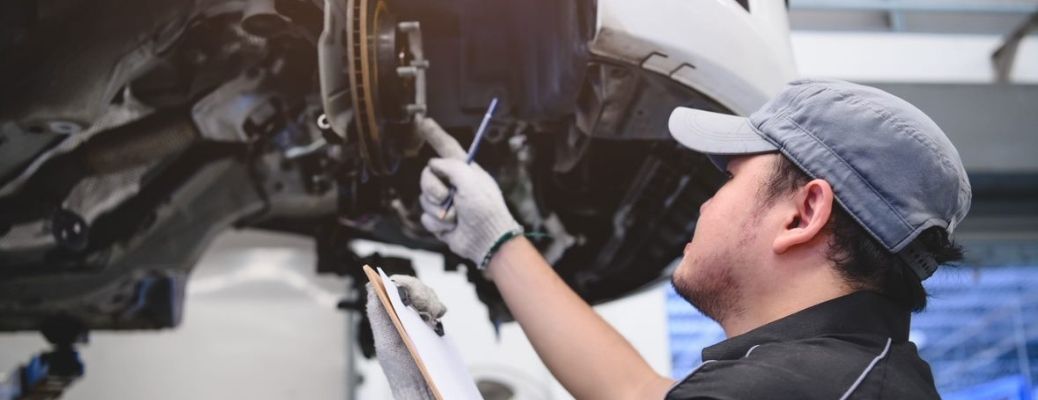 A mechanic checking the brakes of a car