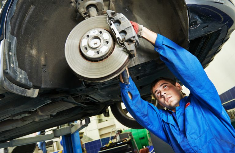 A mechanic fixing the brakes of a car