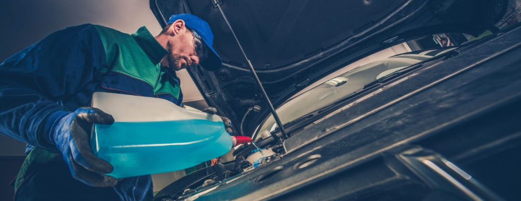 Mechanic pouring cooling oil